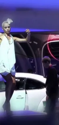 This exciting phone live wallpaper features a woman standing on a gleaming white car amidst a holographic fashion catwalk