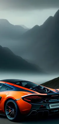 This hyper-realistic phone live wallpaper showcases an orange sports car parked in front of a misty mountain landscape