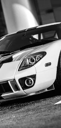 Add excitement to your phone screen with this stunning sports car live wallpaper! Featuring a high-quality black and white photo with a selective color effect, this HQ 4K wallpaper captures the sleek lines of the car and provides a crisp display on your phone