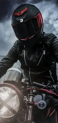 The live wallpaper for your phone features a striking image of a man on a motorcycle in the midst of a thunderstorm