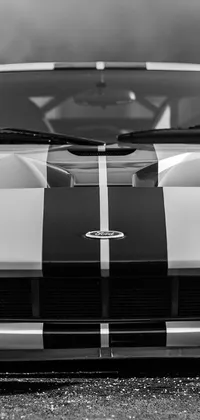 Enhance your phone's look with this stunning black and white live wallpaper featuring a symmetrical front view of a classic sports car