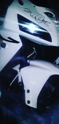 This phone live wallpaper depicts a detailed close-up of a motorcycle parked inside a dim garage