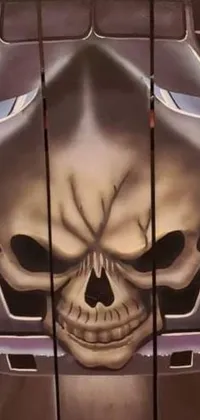 This phone live wallpaper showcases a stunning airbrush painting of a skull on the back of a truck in vivid, bold colors
