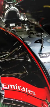 This live wallpaper depicts a high-speed racing car up close in a garage