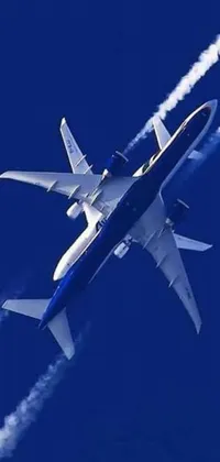 Experience the thrill of flying with this stunning live wallpaper for your phone! A blue and white jet soars through a gradient blue sky with scattered white clouds