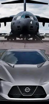This live wallpaper for your phone features a silver sports car sitting on an airport tarmac with runway lights in the background creating a modern and sleek aesthetic