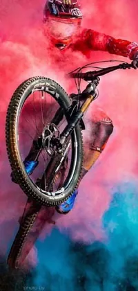 This phone live wallpaper features a stunning airbrush painting of a man riding a bike through the air