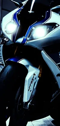 This live phone wallpaper brings the beauty of a white and blue BMW motorcycle parked in a garage to life with photorealistic visuals and stunning lighting effects