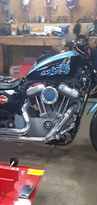 This stunning live wallpaper depicts a blue motorcycle under repair in a garage
