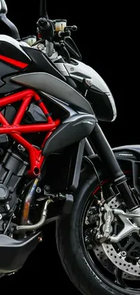This stunning live wallpaper depicts a stylish red and black motorcycle against a black background with intricate details giving it an ultra-detailed face