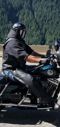 This dynamic live wallpaper features the thrilling image of a rider on a motorbike tearing down a winding road while donning a tactical latex poncho