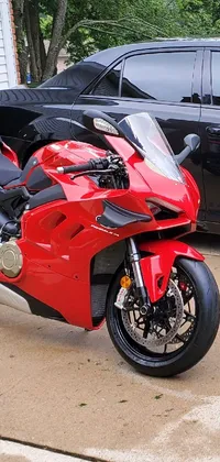 This bold live phone wallpaper shows a red motorcycle parked beside a black car