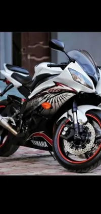 This live wallpaper for phones displays a white R6 motorcycle parked on the side of the road