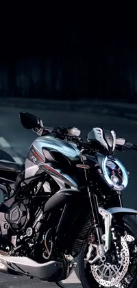This live wallpaper features a photorealistic image of a parked motorcycle at night