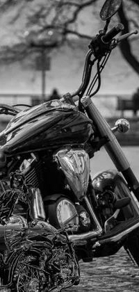 This phone live wallpaper showcases a black and white HDR detail photo of a motorcycle by a photographer
