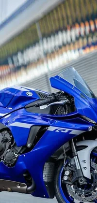 Get ready to give your phone's wallpaper a trendy update with this ultra-detailed live wallpaper! Featuring a cobalt blue, front-facing R6 motorcycle parked by the side of the road, this wallpaper is a perfect fit for anyone who's a fan of motorbikes, speed, and high-adrenaline experiences! With all its intricate details and high-definition graphics, the blue motorcycle practically jumps out of your phone's screen, adding an electrifying element to your phone usage experience! So if you want to make your phone stand out, download this stunning cobalt blue R6 wallpaper now!