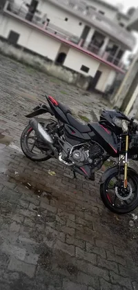 Get revved up with this stunning phone live wallpaper featuring a sleek black Pulsar motorcycle parked alongside a charming brick road