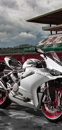 Looking for an edgy and powerful wallpaper for your phone? Check out this live wallpaper featuring a stunning white motorcycle parked in a dynamic parking lot