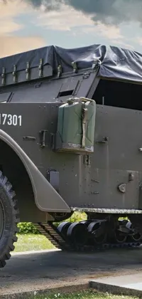 This phone live wallpaper depicts a military vehicle on the side of the road