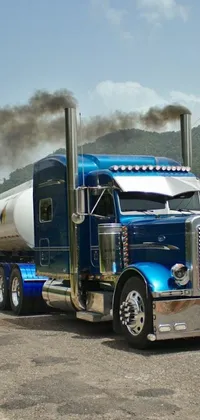 This live phone wallpaper portrays a smoking tanker trailer attached to a semi truck