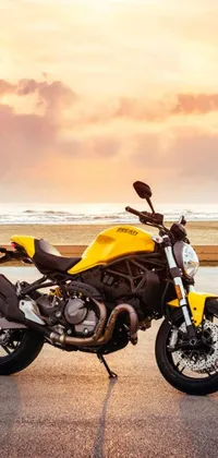 Get mesmerized by this stunning yellow motorcycle parked beside the road in this phone live wallpaper
