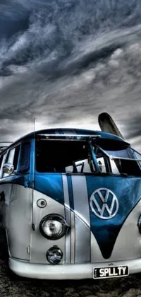 This mobile live wallpaper showcases a striking Volkswagen bus on a sandy beach