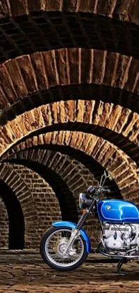 Get ready to rev up your phone screen with this amazing live wallpaper! Featuring a stunning blue vintage motorcycle parked in front of a brick tunnel, this design is perfect for fans of photorealistic artwork