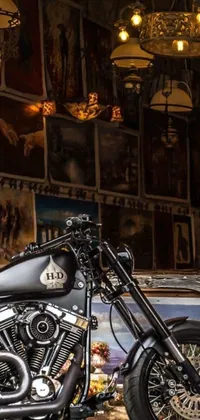 This live wallpaper features a sleek black motorcycle parked in a garage surrounded by high-detail elements like tools and oil-stained floors