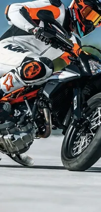 Rev up your phone's lock or home screen with this dynamic live wallpaper! Featuring a crouching figure on the back of an orange and black motorcycle, this thrilling close-up shot captures the excitement of the open road
