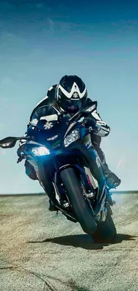 Experience the freedom of the open road with this phone live wallpaper featuring a photorealistic image of a man riding a blue Kawasaki motorcycle