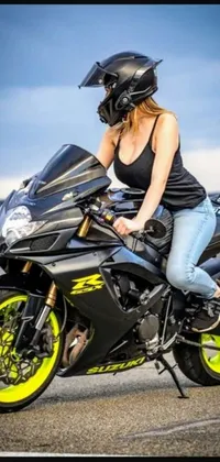 This phone live wallpaper displays an alluring image of a woman riding on a motorcycle