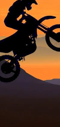 This live phone wallpaper depicts a dirt bike ride through the air in stunning HD detail