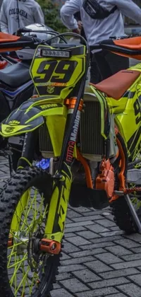 This high-detail live wallpaper features a pair of race-style dirt bikes parked next to one another