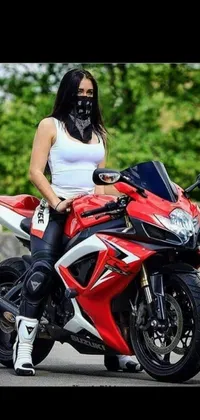 This phone live wallpaper depicts a red motorcycle with a woman rider
