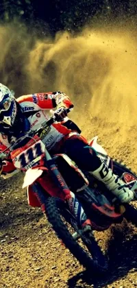 This live wallpaper depicts a dirt bike rider tearing through a dirt track with red sand