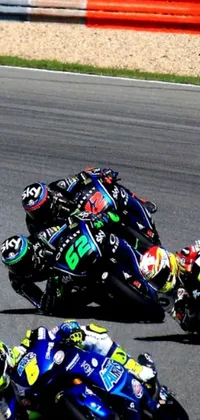 This dynamic live wallpaper showcases a thrilling scene of motorcyclists racing down a professional track in a vivid black, blue, and green color scheme