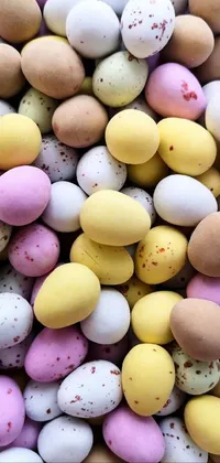 This phone's lively wallpaper features a pile of colorful chocolate eggs arranged on a white plate