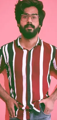 This visually stunning phone live wallpaper presents an equally stunning portrait of a confident young man sporting a pink shirt with red and white stripes