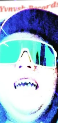 This phone live wallpaper features a close-up shot of an individual wearing sunglasses, with an impish smile on their face