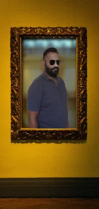 This phone live wallpaper depicts an album cover-inspired image of a bearded man standing in front of a large picture of himself