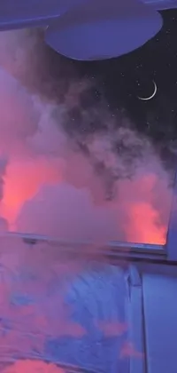 This live wallpaper for phones depicts a digitally created night sky, seen through a large window above a comfortable bed