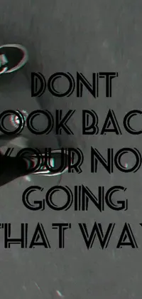 This phone live wallpaper features a black and white image with the words "don't look back, your not going that way