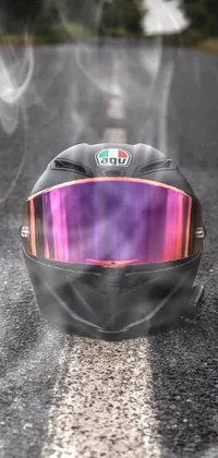 Decorate your phone with a stunning live wallpaper of a shiny helmet set in Italy! This wallpaper features an artfully crafted design in rose gold, violet, and black tones, complete with an iridescent visor that shimmers in the light