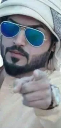 This live wallpaper showcases a confident man wearing a traditional turban, stylish sunglasses, and pointing directly at the camera