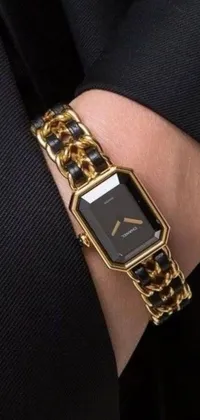 This stylish phone live wallpaper showcases a close-up of a hand with a sophisticated watch in black and gold colors