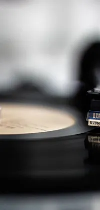 This dynamic phone live wallpaper showcases a captivating close up of a record on a table