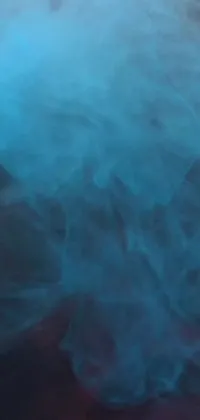 Enjoy a stunning live wallpaper featuring a mesmerizing blue substance floating in water, resembling smoke swirling from the depths