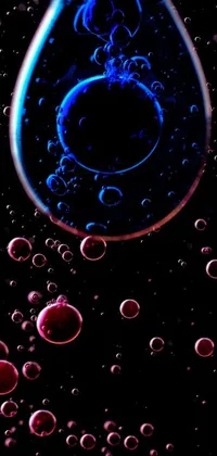 Looking for a striking live wallpaper that will turn heads and upgrade your phone's visuals? Look no further than this stunning creation! Featuring a mesmerizing close-up of a water droplet with bubbles, this wallpaper draws inspiration from the works of artist Otto Piene for a truly unique aesthetic