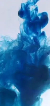 This phone live wallpaper features a mesmerizing close-up of a blue substance swirling in water