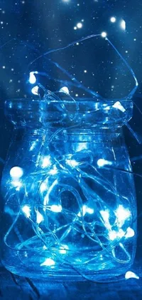 This phone live wallpaper features a captivating jar filled with illuminating fairy lights on a beautifully crafted table